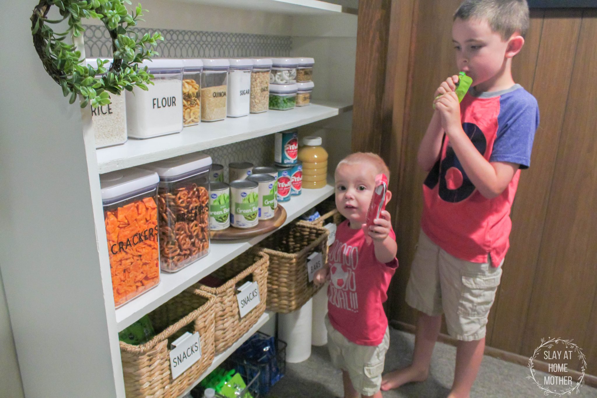 Our kids easily grabbing snacks from our snack shelf in our newly renovated pantry!