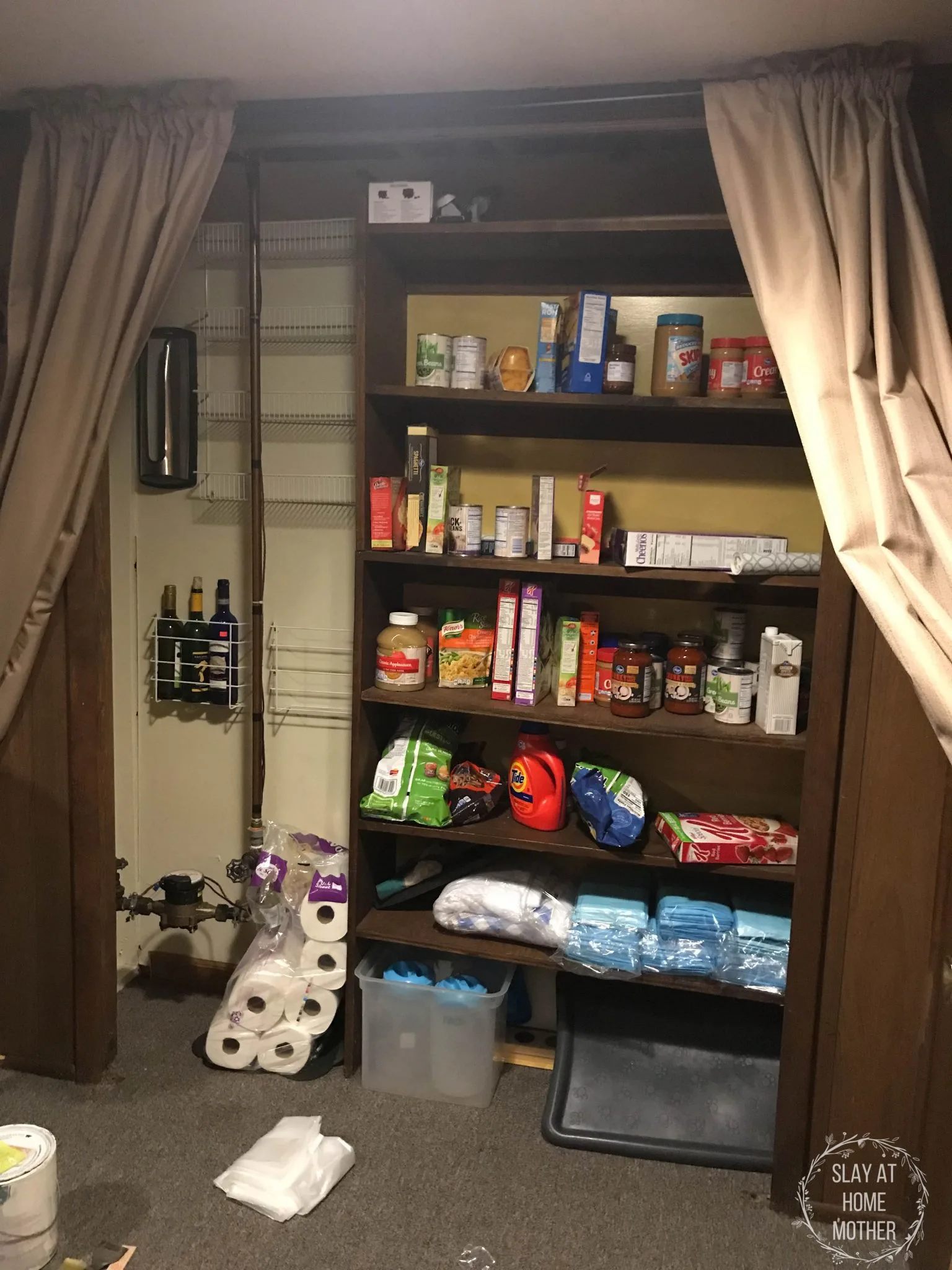My small pantry with brown shelves, mustard yellow walls, and mess everywhere