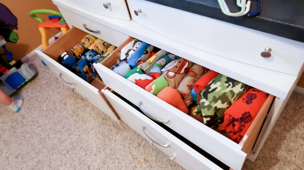 open kids dresser drawers showing neatly folded pajama sets