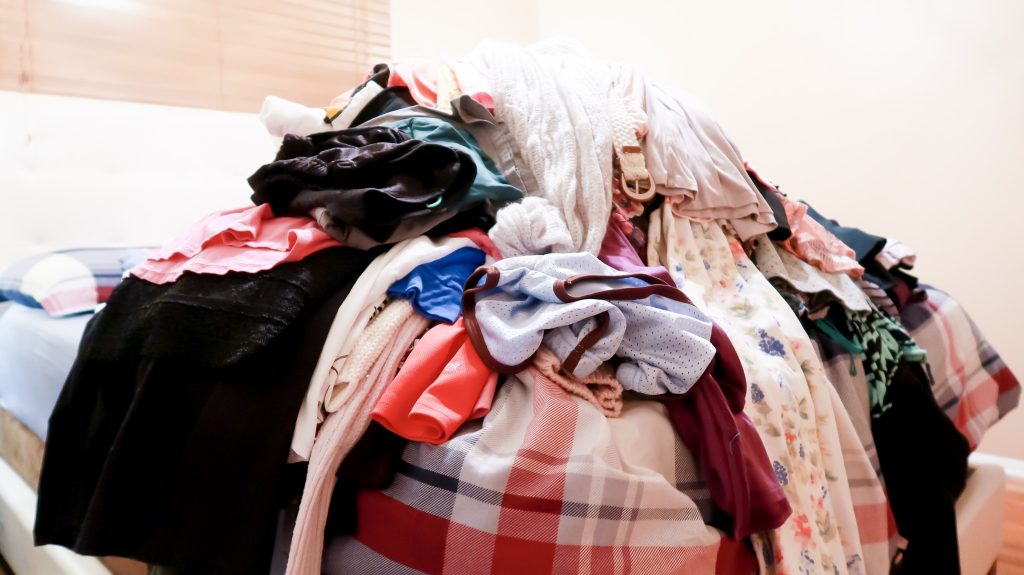 horizontal shot of clothing purged from master bedroom closet