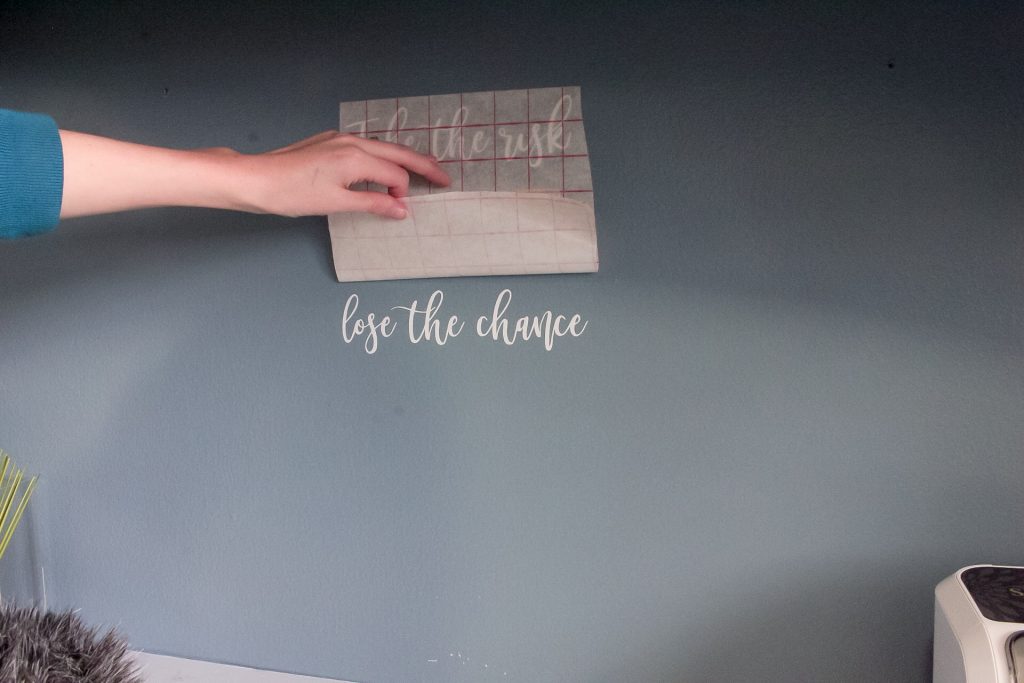 Gently pull away the transfer paper to see if the letters are sticking to the wall.