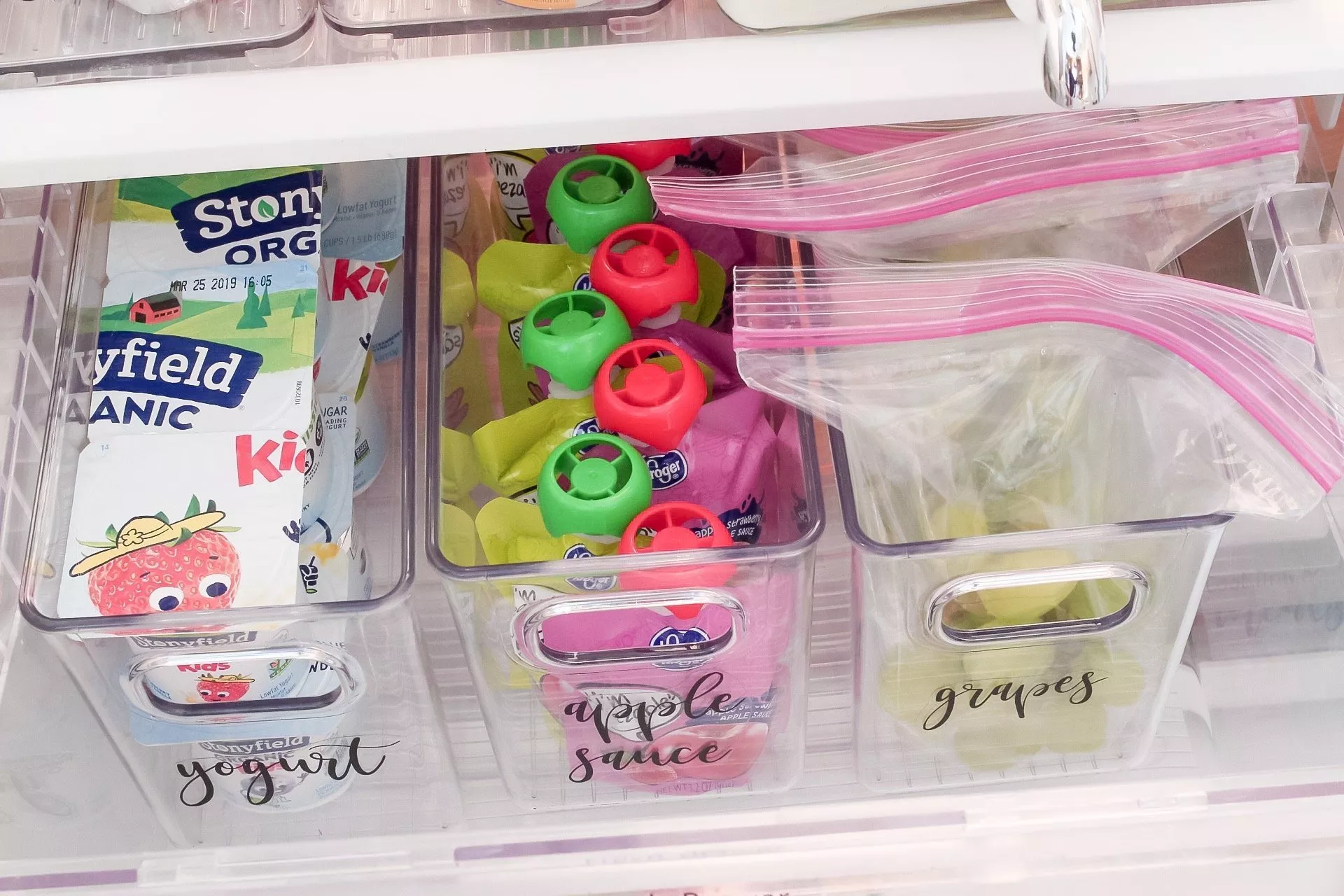 Our handy snack drawer in our organized fridge that the kids can easily grab snacks from