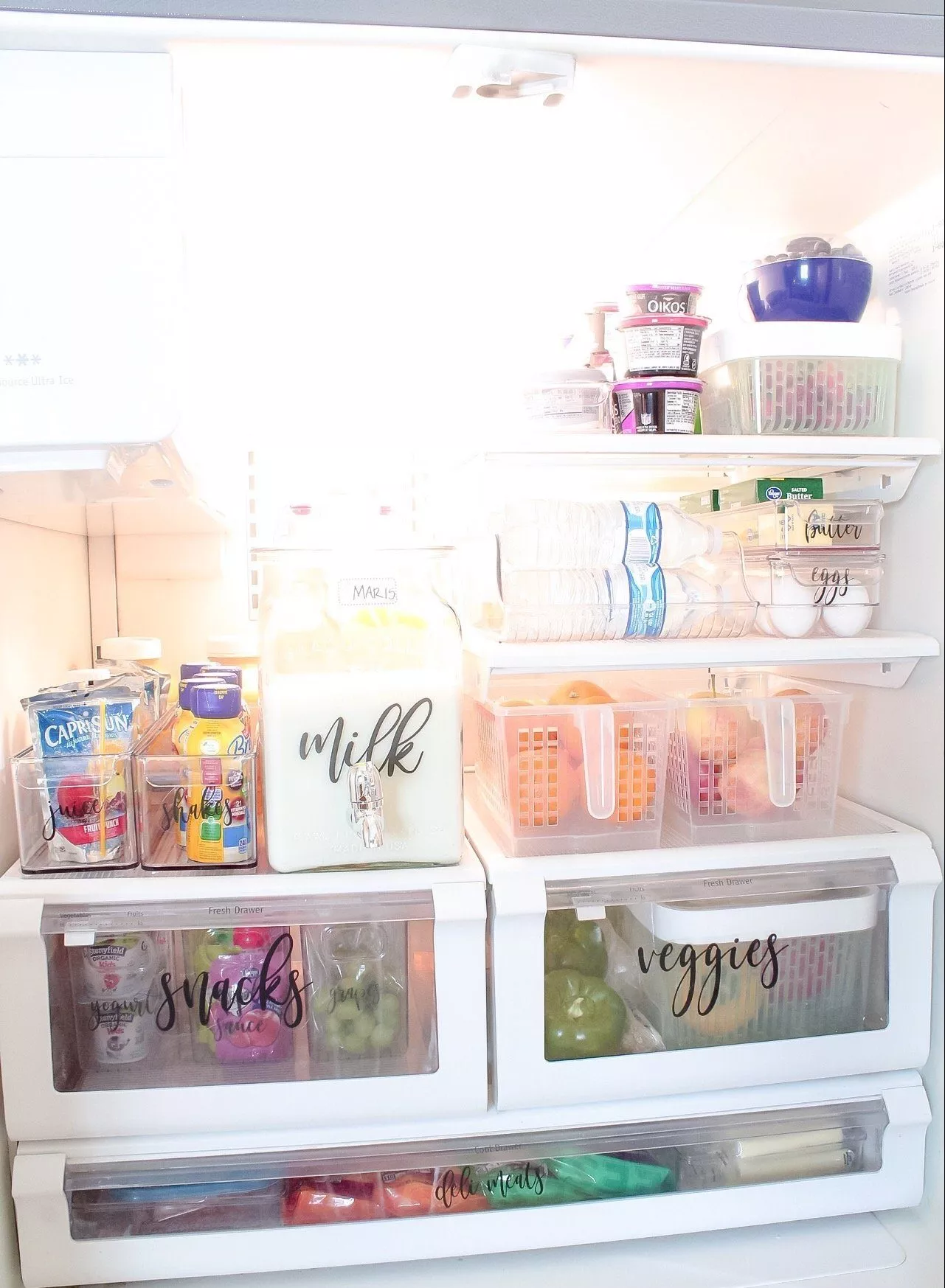 My completely organized fridge, with veggies and fruit in bins, milk in a new container, etc.