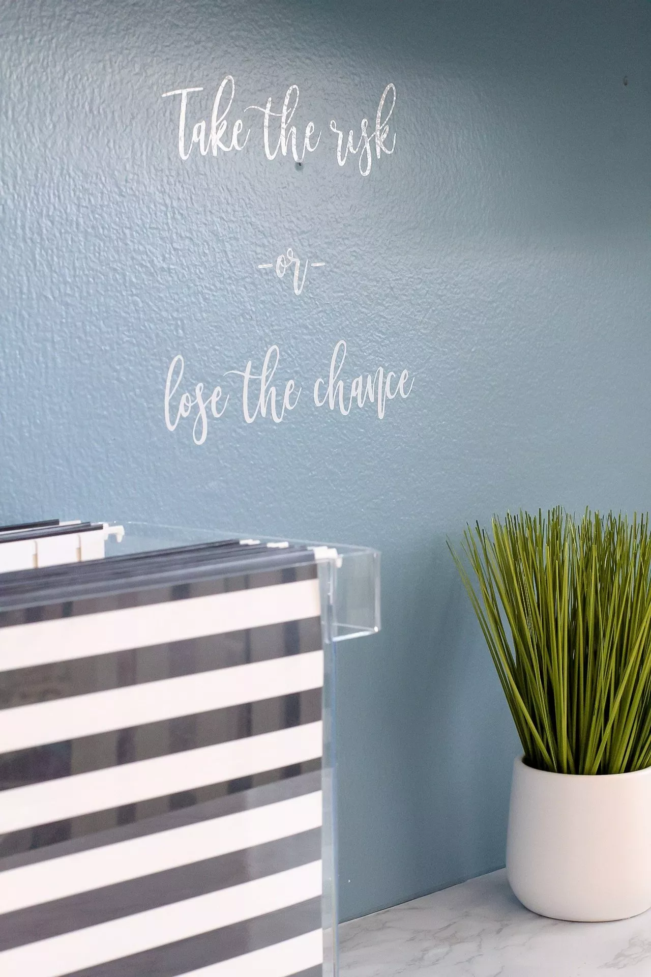 White wall decal that reads: Take the risk or lose the chance