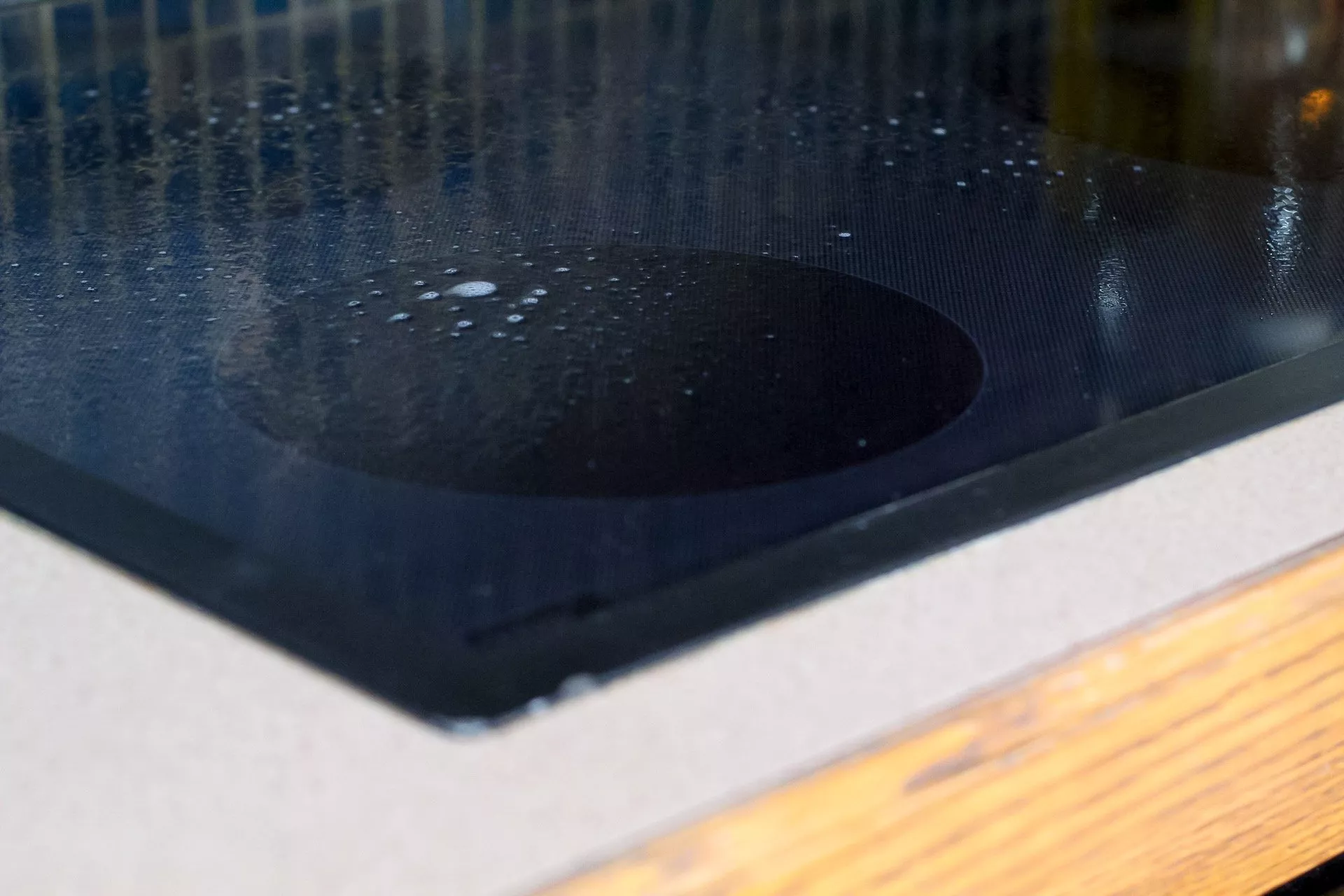 View of sprayed kitchen degreaser solution on stovetop