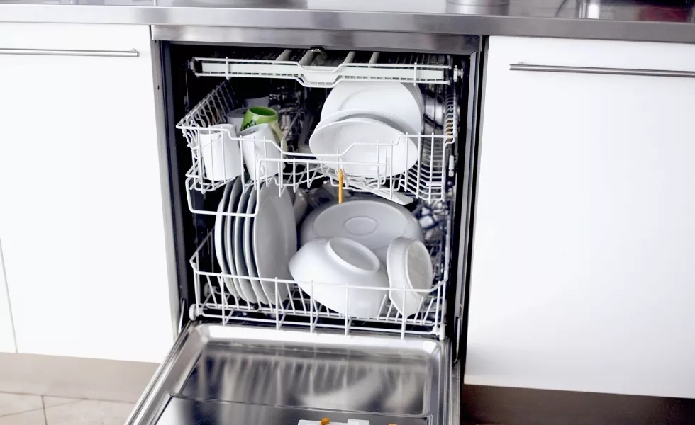 a dishwasher filled with plates and bowls and cups