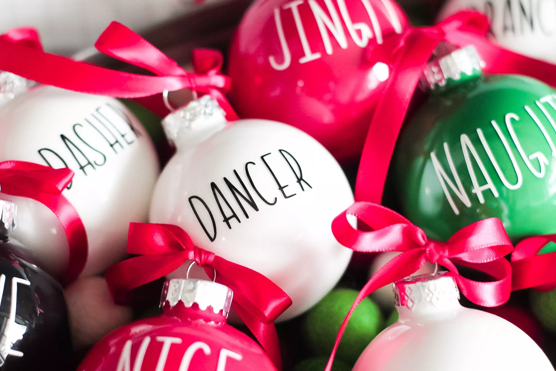 closeup of vinyl letters on painted christmas ornaments