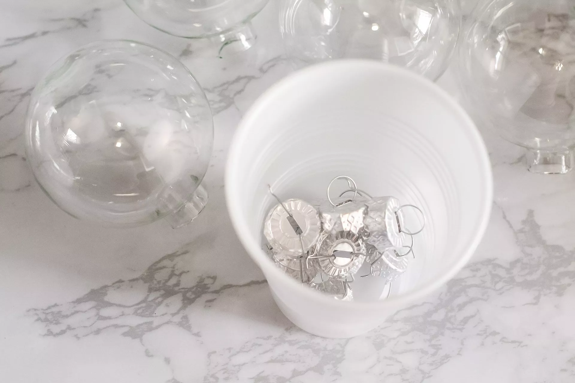 glass ornament tops removed and placed in a cup