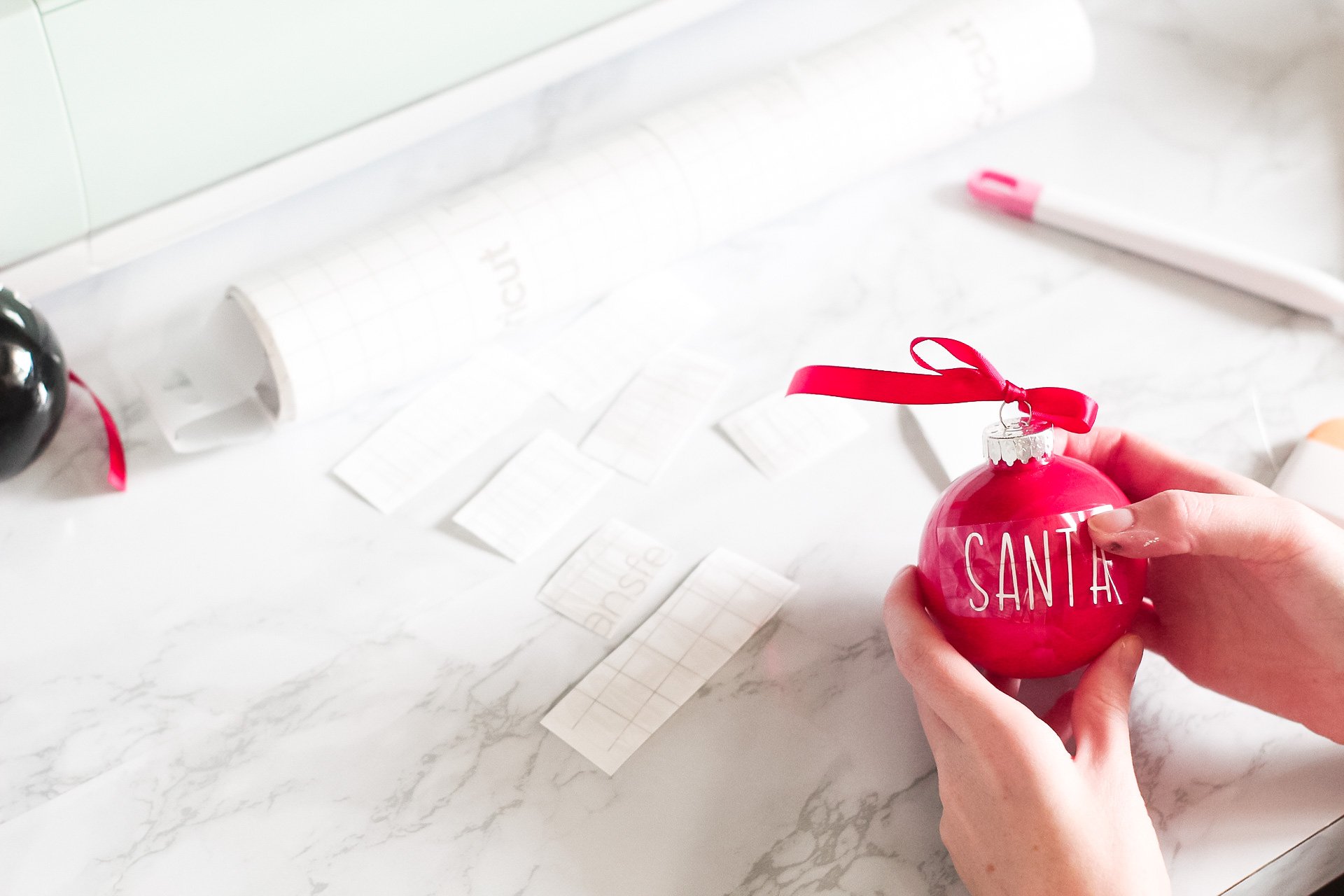 pushing letters onto christmas ornaments