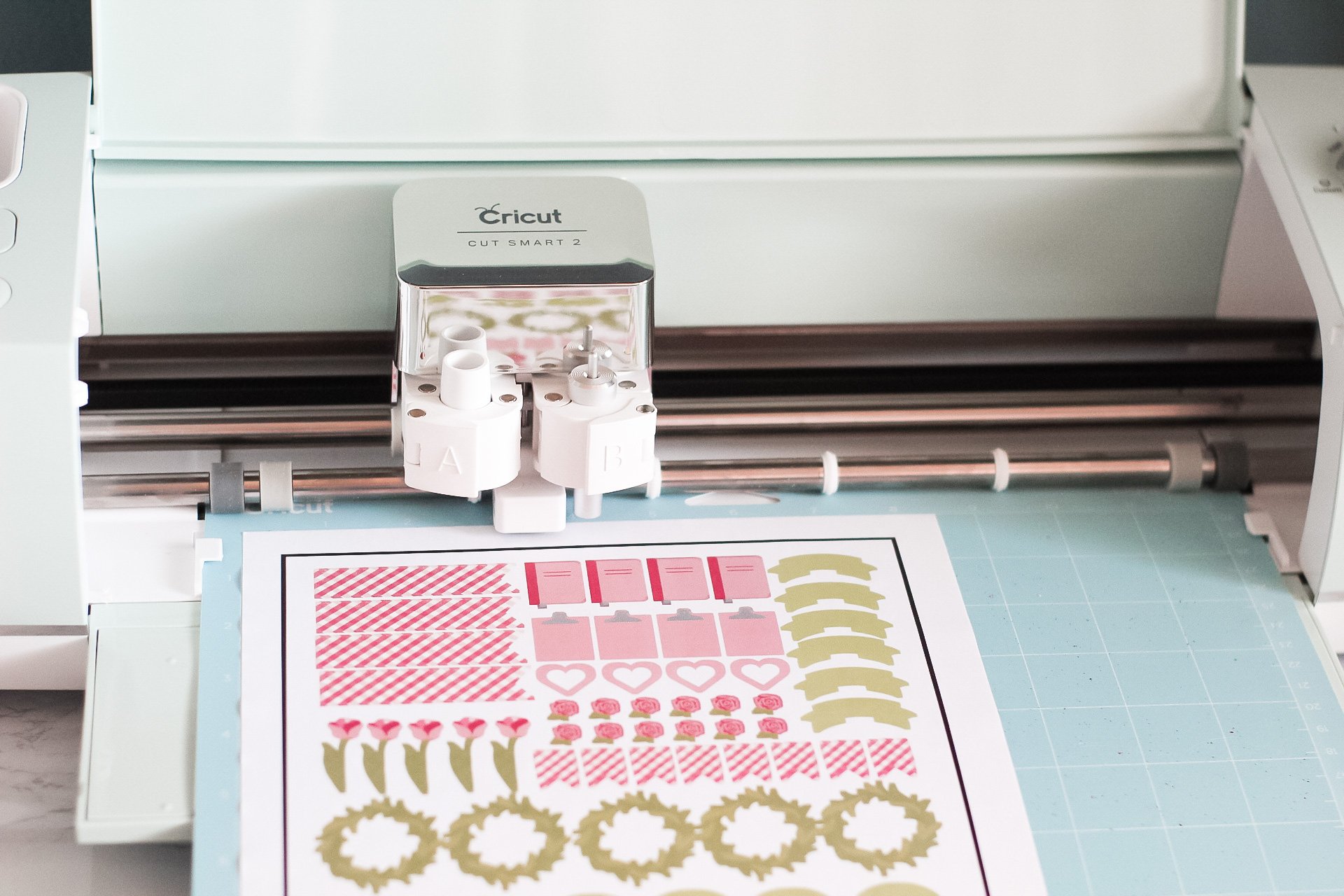 sticker paper and lightgrip mat loaded into cricut explore air 2