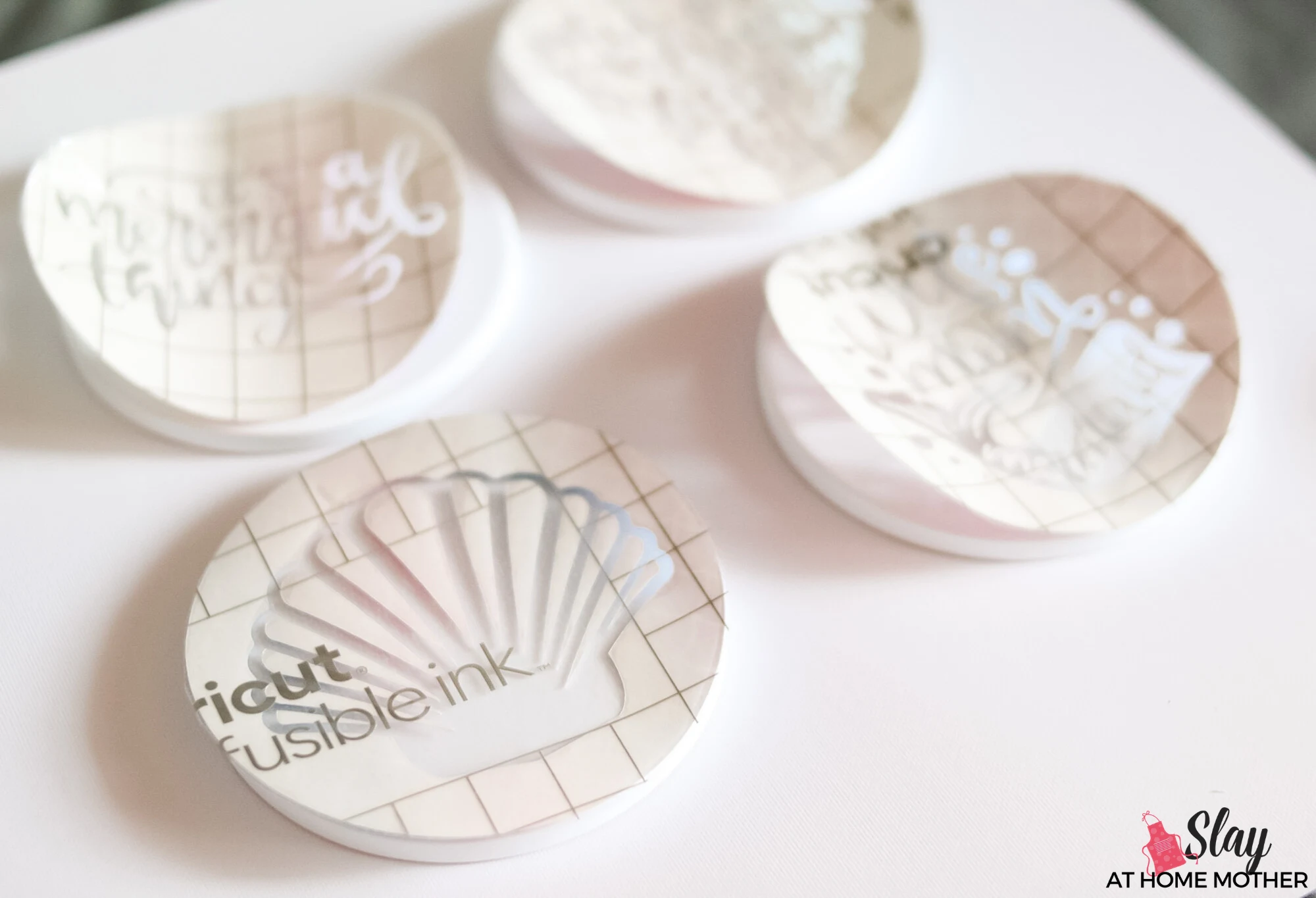 infusible ink transfer sheets on top of cricut coasters
