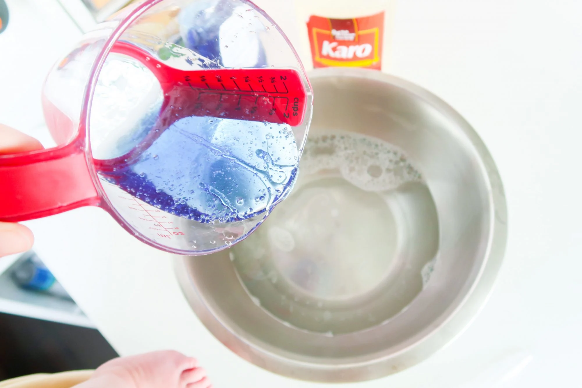 pouring Dawn dish soap into mixing bowl