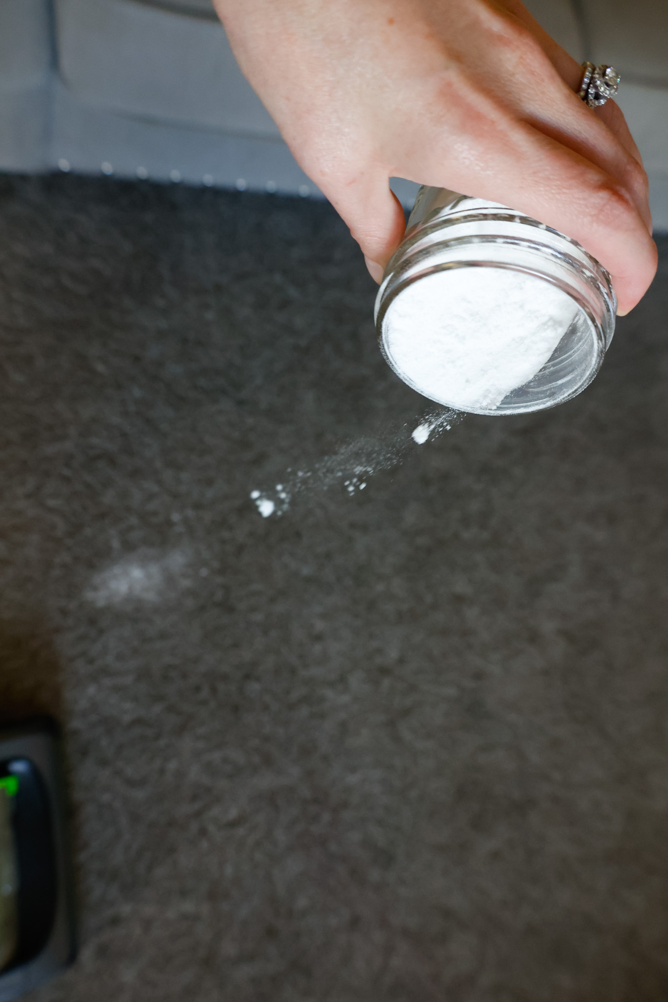 sprinkling carpet powder on carpet