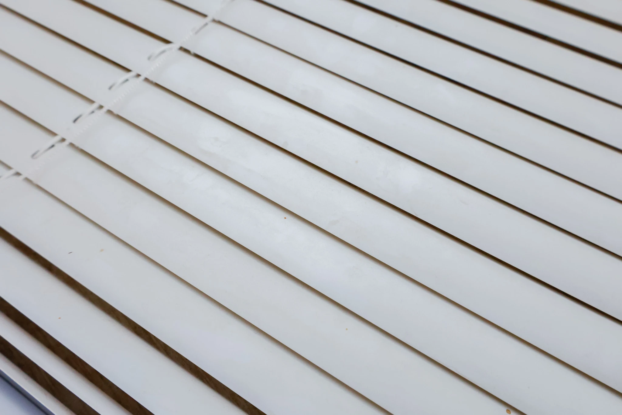closeup shot of mini blinds slats covered with dust