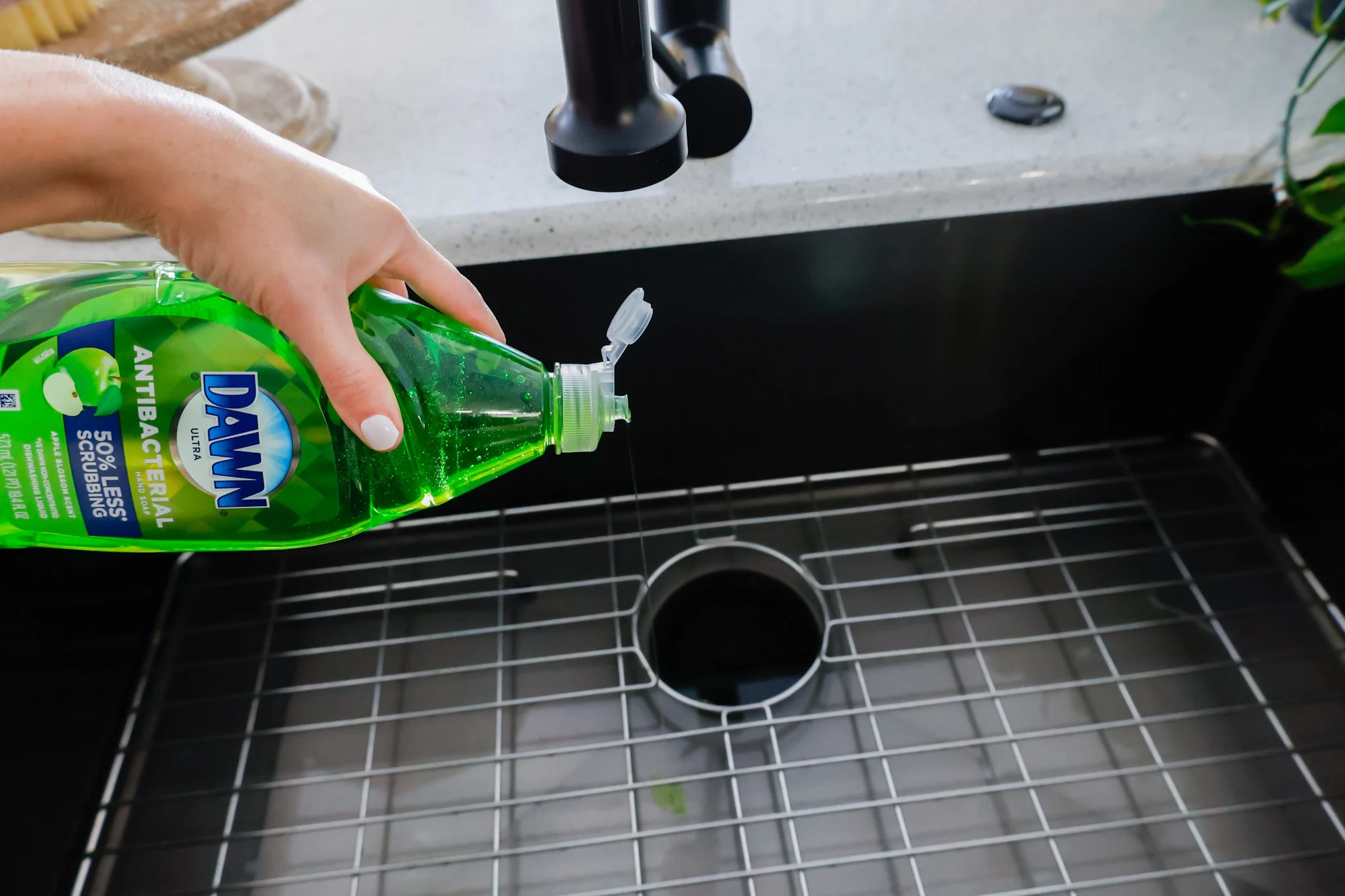 squirting dish soap into our farmhouse sink