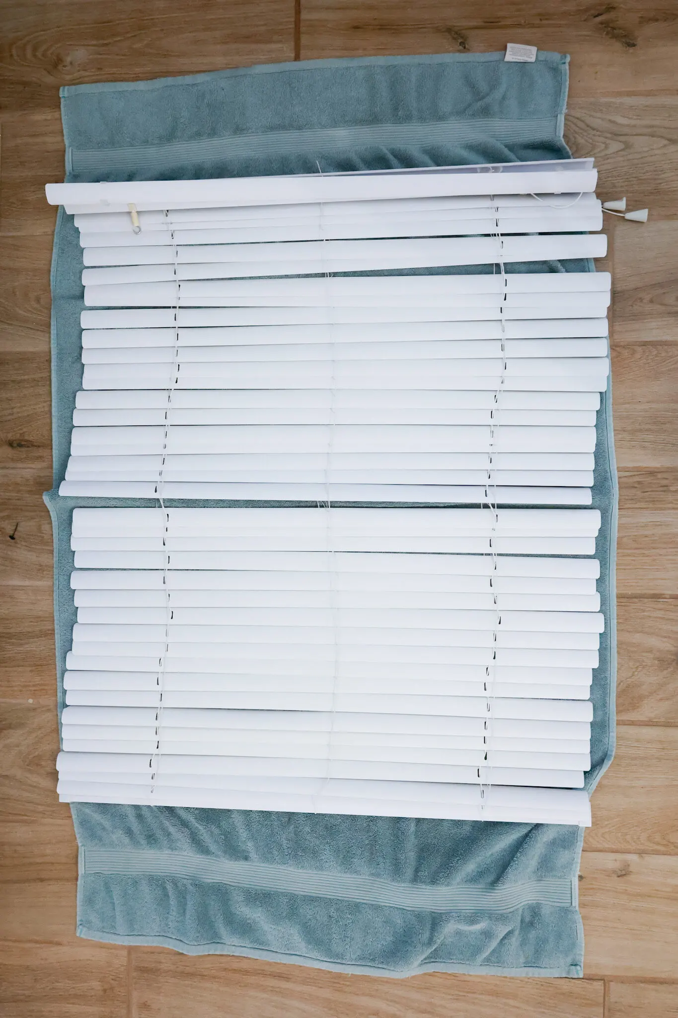 cleaned blinds laid on towel to air dry