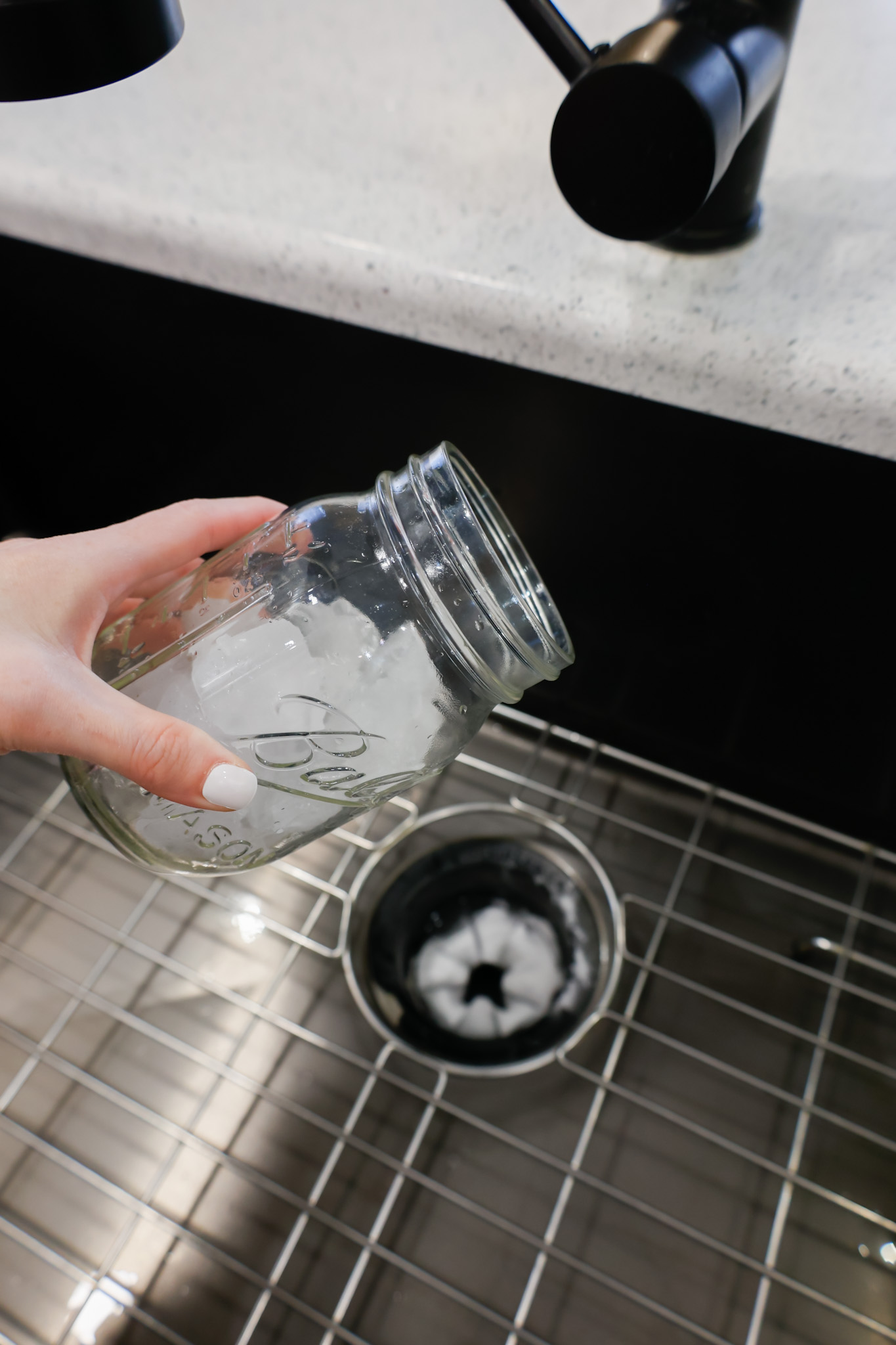 pouring ice cubes into the garbage disposal