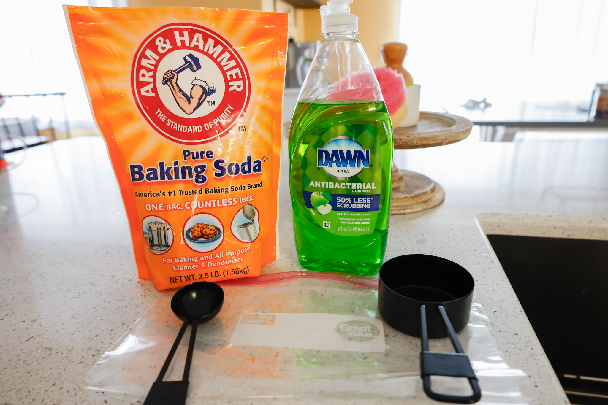 baking soda and dish soap with measuring cups and ziploc bag