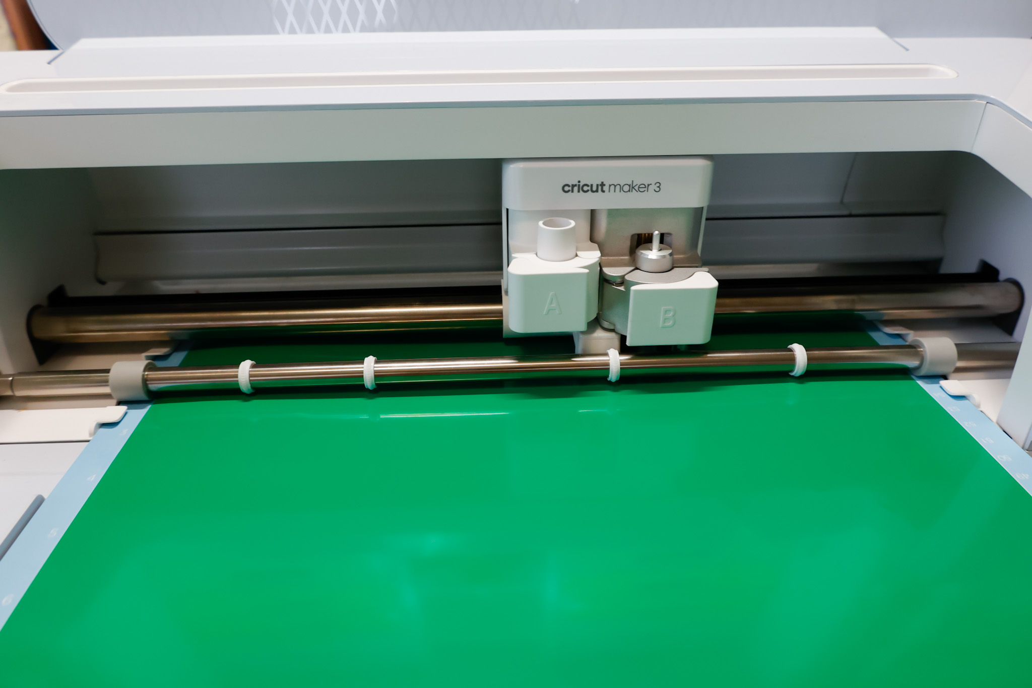 Cricut Maker 3 cutting green permanent vinyl