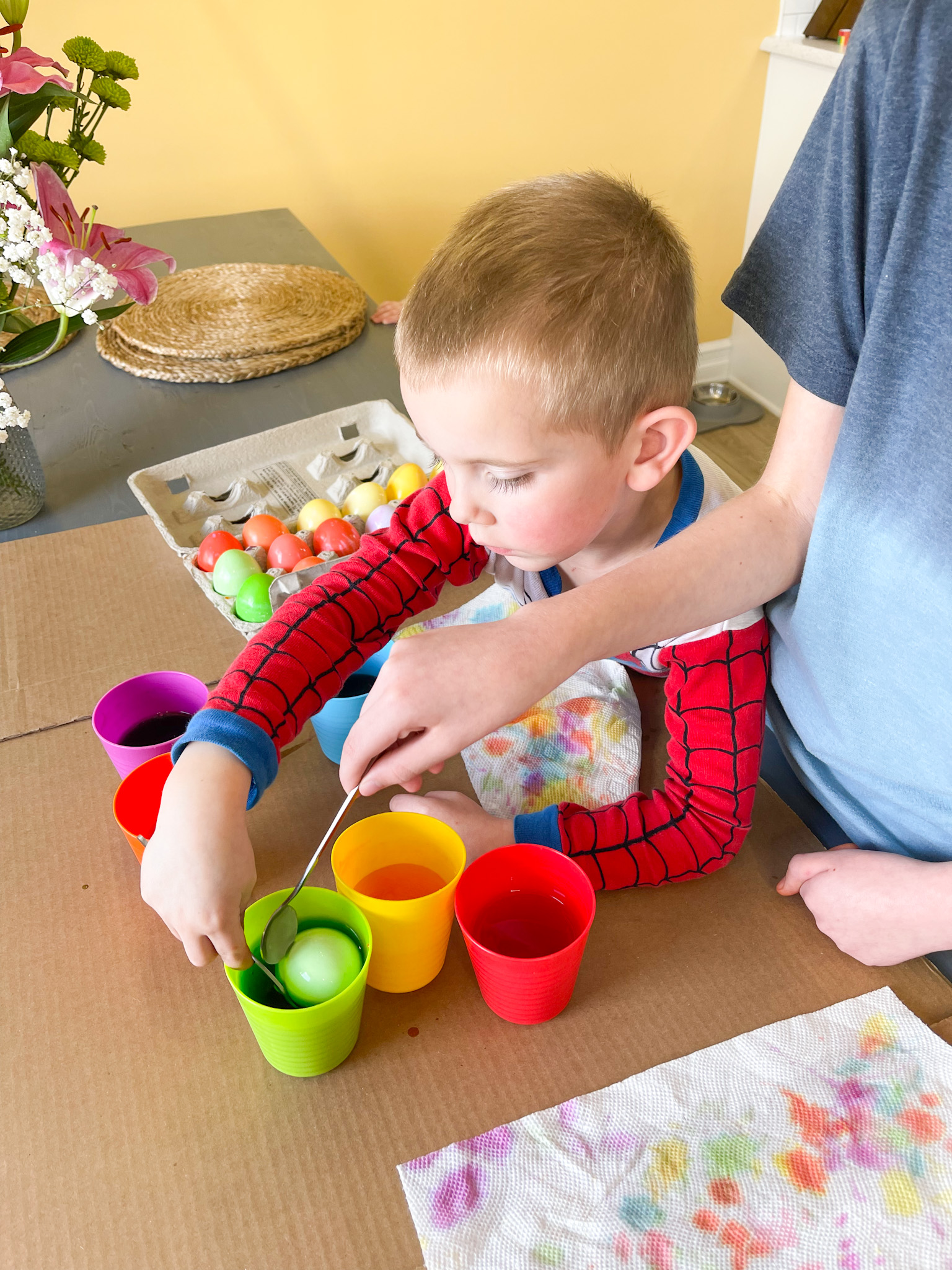 kids dying easter eggs with food coloring