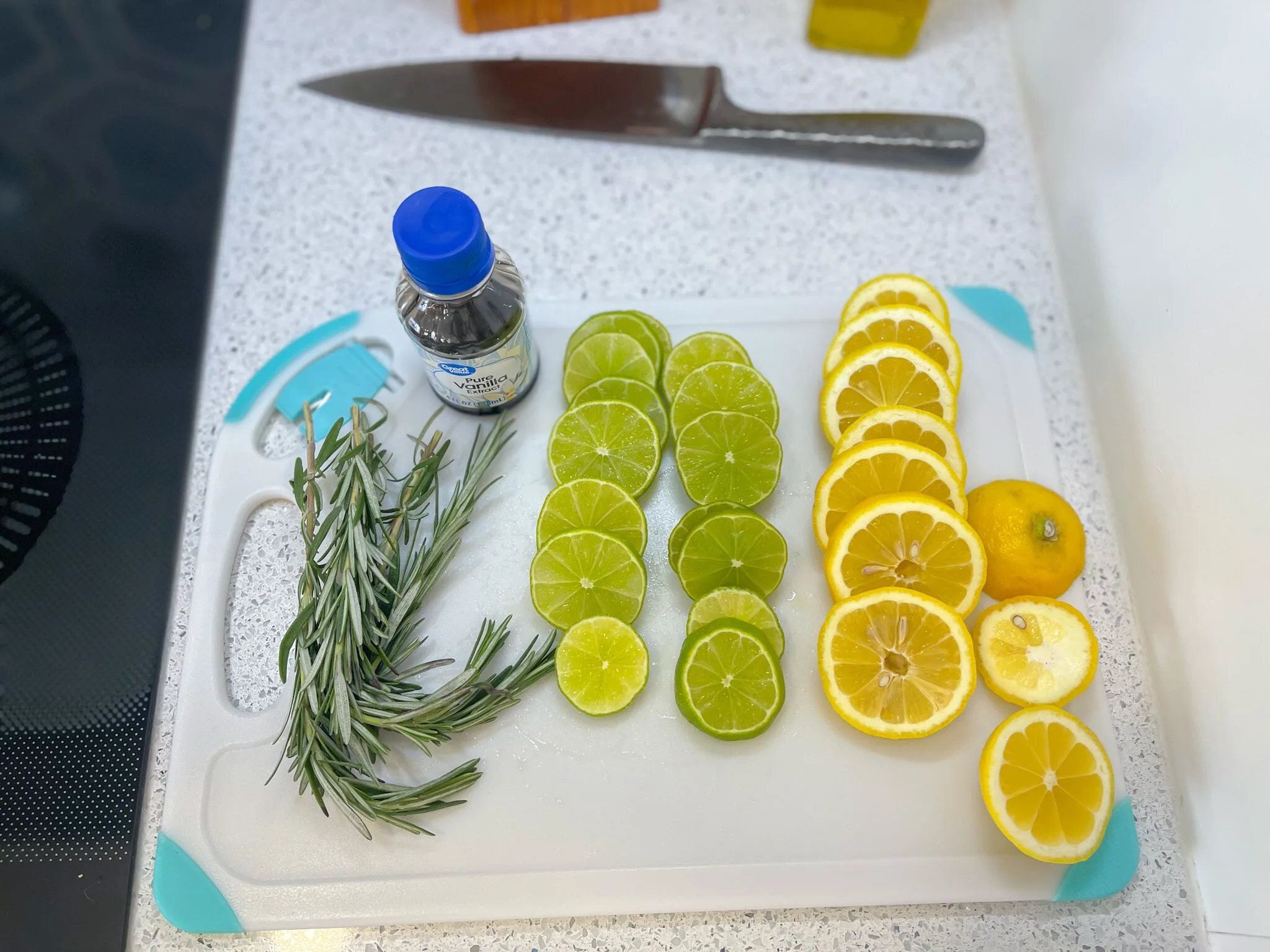 sliced lemons and limes on cutting board to make stovetop potpourri