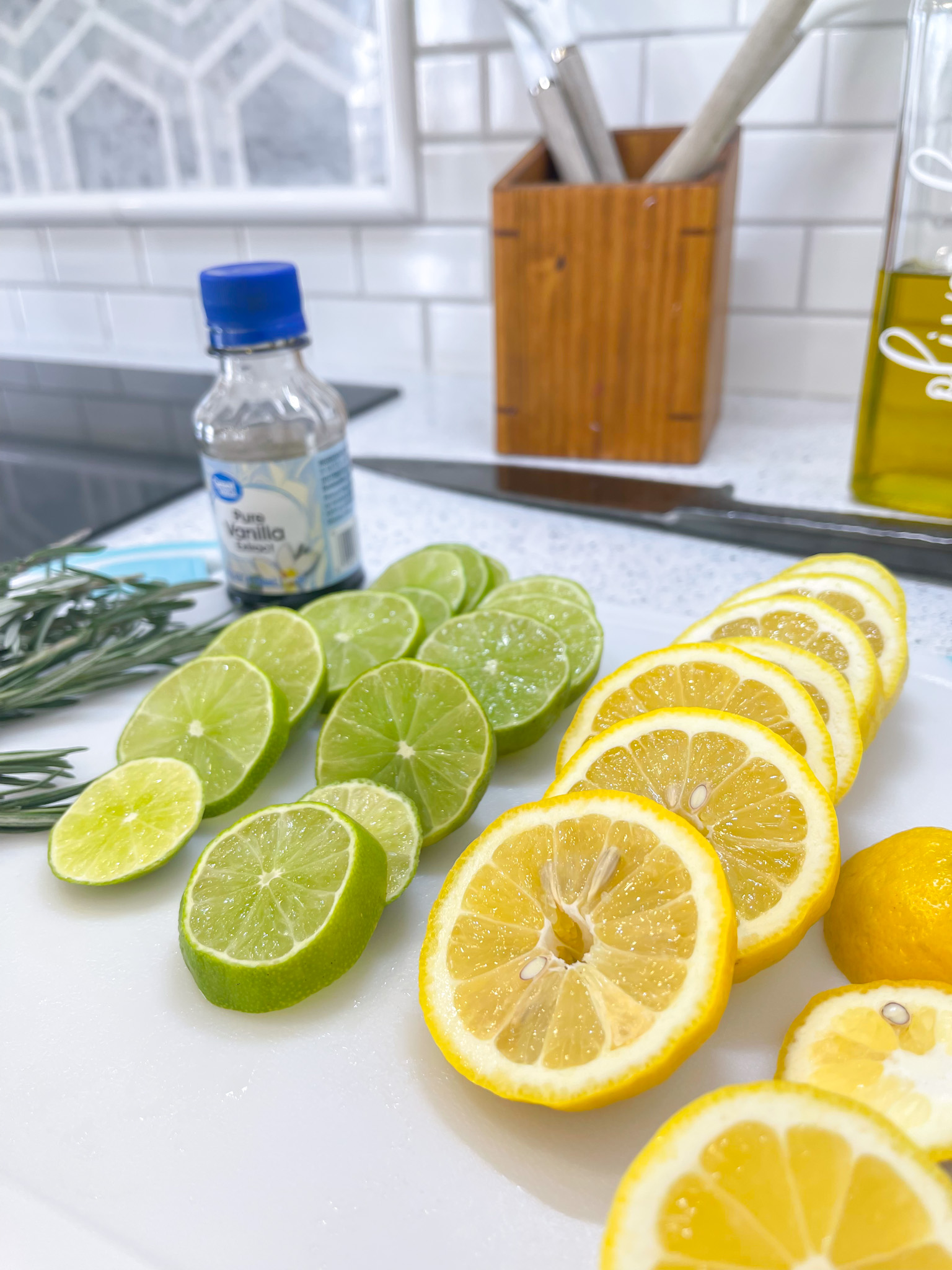 sliced lemons and limes on cutting board to make stovetop potpourri