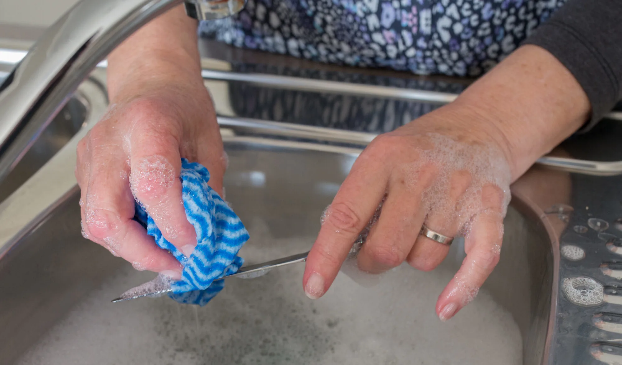 cleaning knife blade in sink