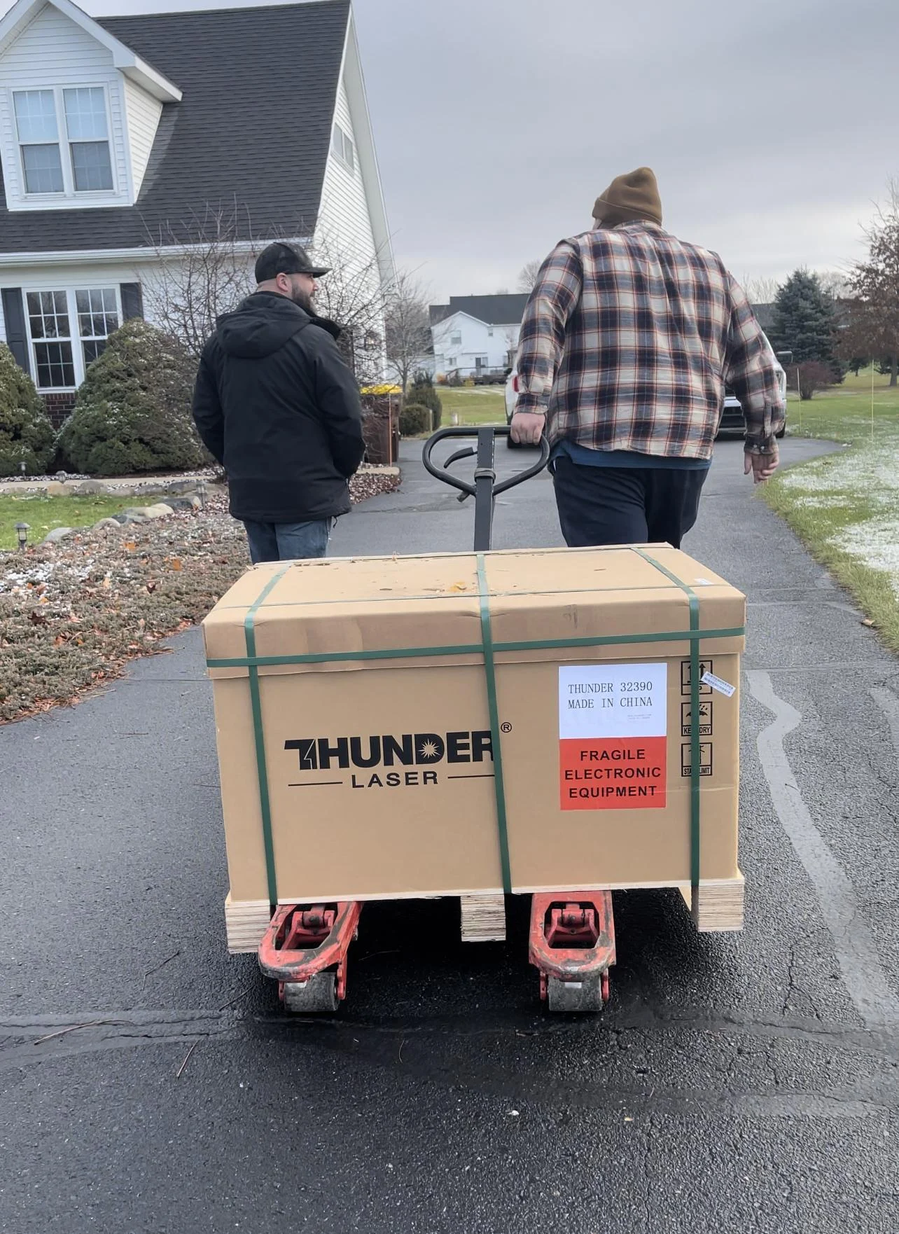 Driver wheeling up the Thunder Bolt Laser up the driveway