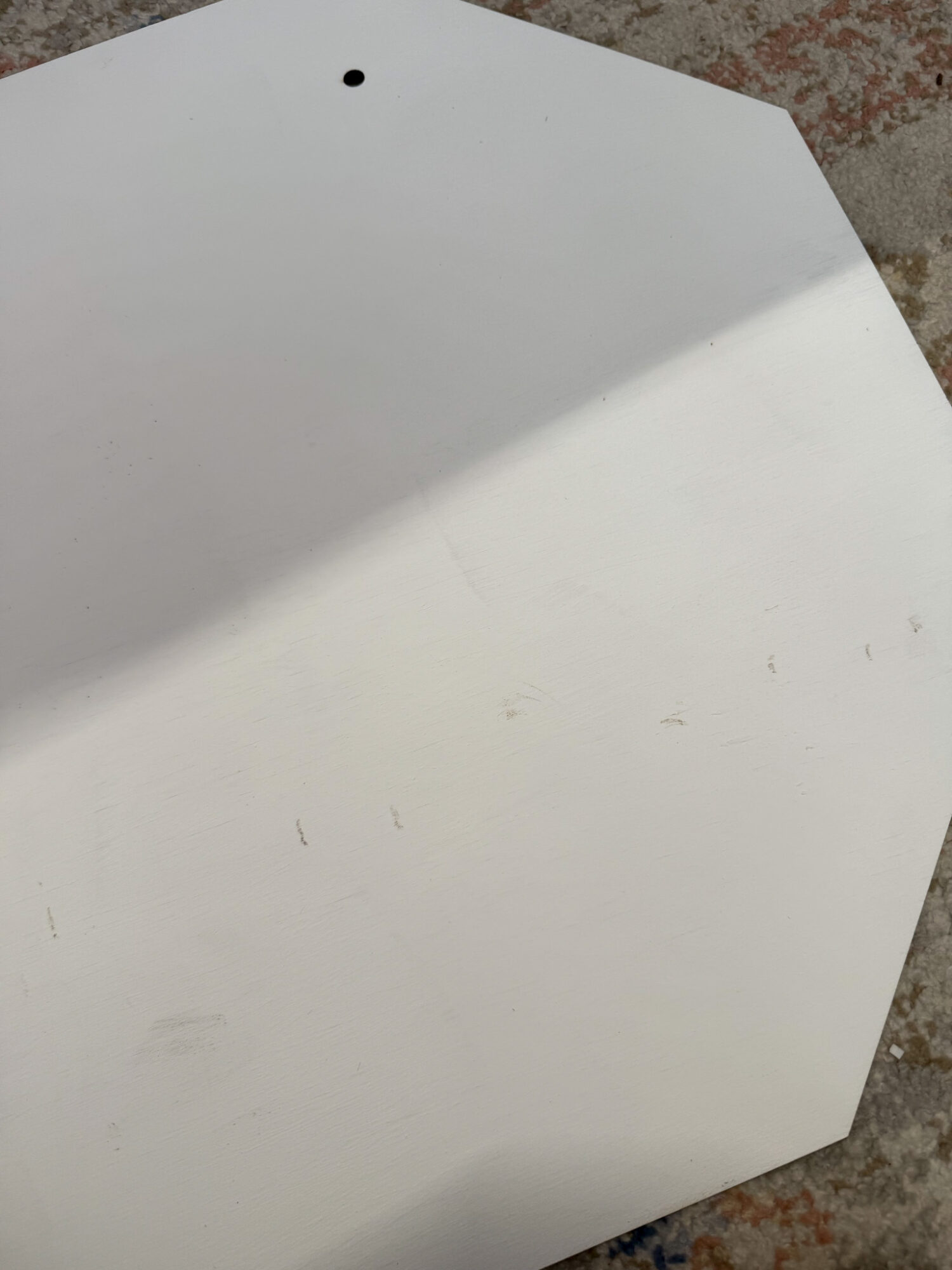 diy santa stop here sign with scuffed up marks on white octagon