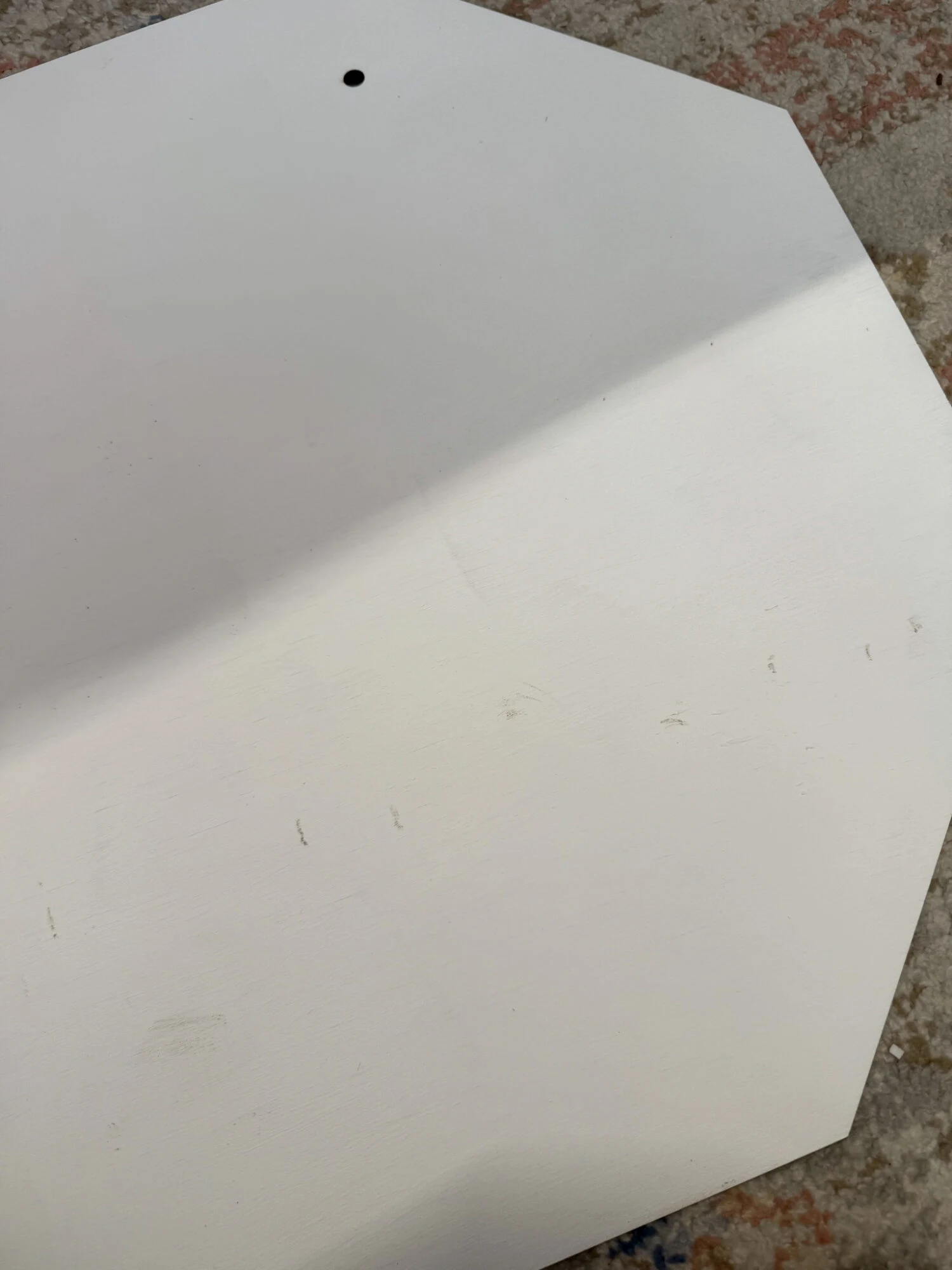 diy santa stop here sign with scuffed up marks on white octagon