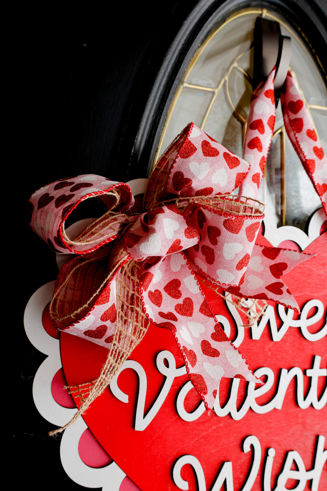 closeup of finished double layer bow on valentines day door sign