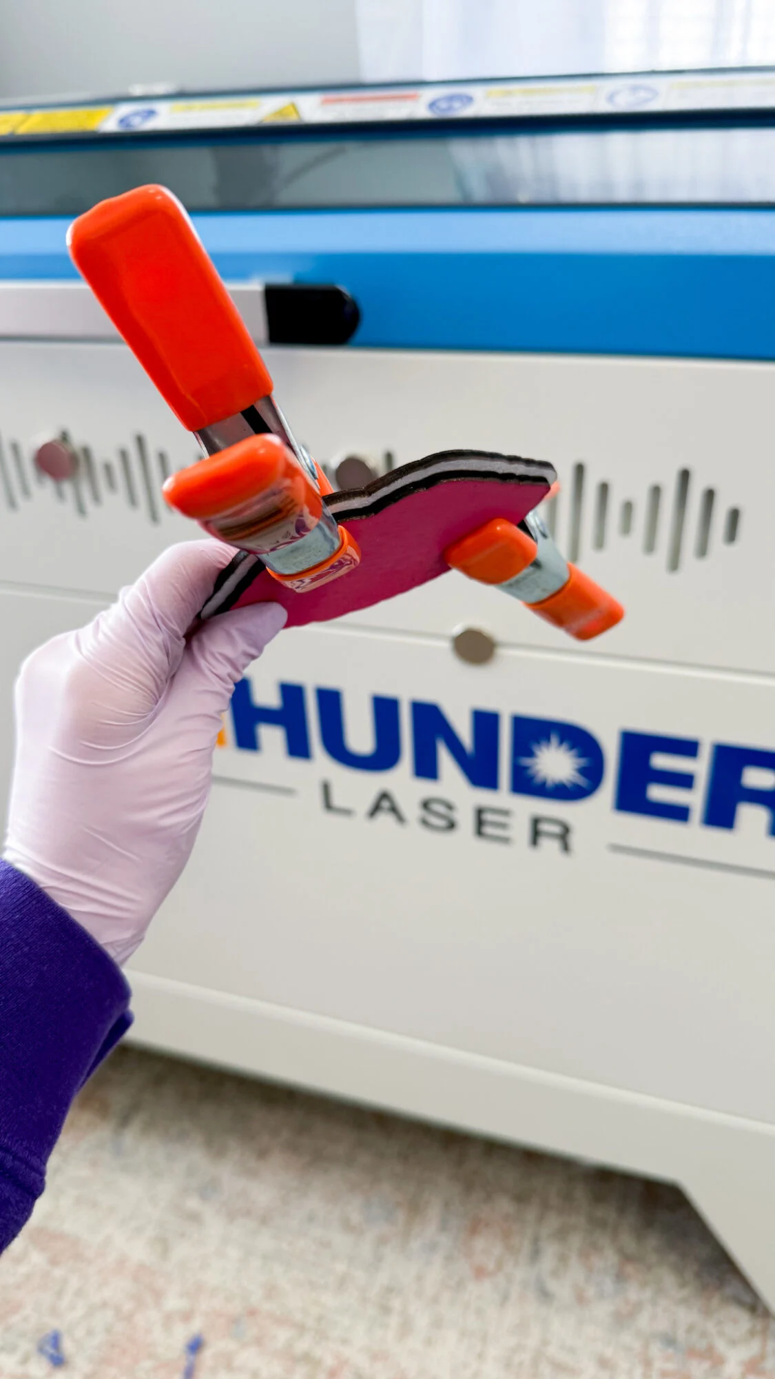 clamps holding glued layers of wood together after cutting