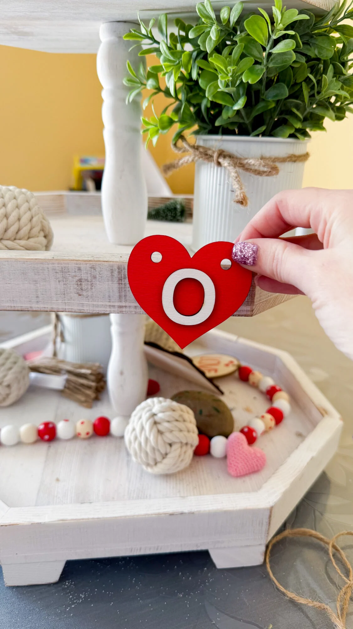 placing laser cut wood shape onto tiered tray